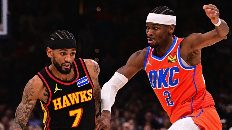 Nickeil Alexander-Walker #7 of the Atlanta Hawks attempts to move past Shai Gilgeous-Alexander #2 of the Oklahoma City Thunder.