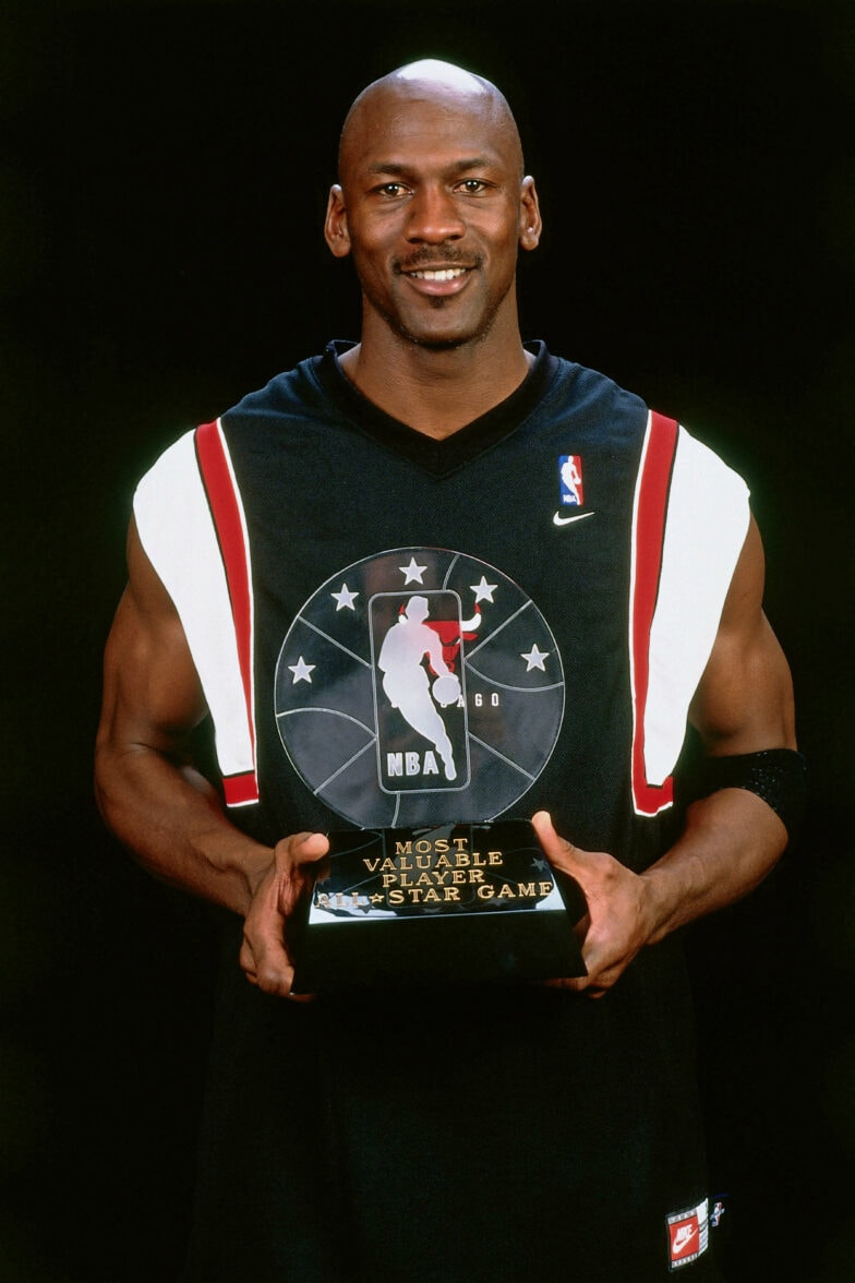 Michael Jordan posing with the All-Star Game MVP award