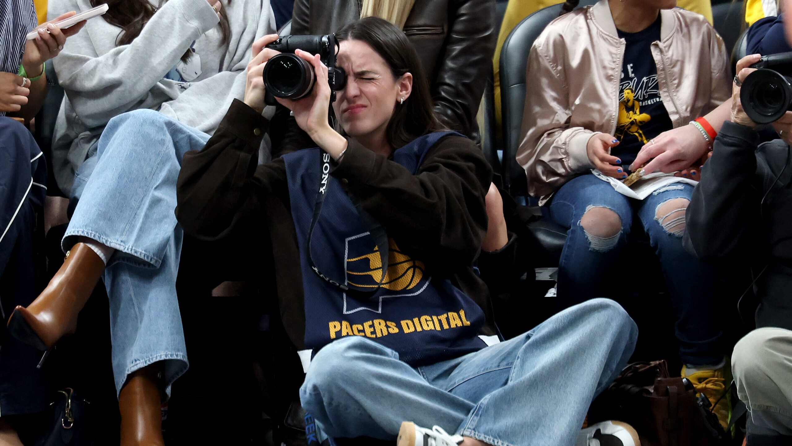 Caitlin Clark works as a photographer for the Indiana Pacers as they host LeBron and the Lakers