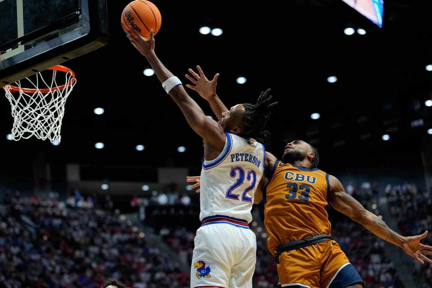 Peterson scores 28 points as Kansas hangs on to beat March Madness newcomer Cal Baptist 68-60