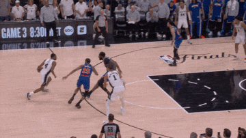 Victor Wembanyama misses a 20-foot midrange jumper off a feed from De'Aaron Fox, falling to the ground as Mitchell Robinson contests the shot.