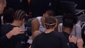 Victor Wembanyama passionately rallies his team in the huddle.