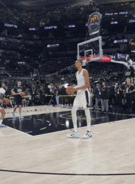Victor Wembanyama hits a three-quarters court shot in warmups.