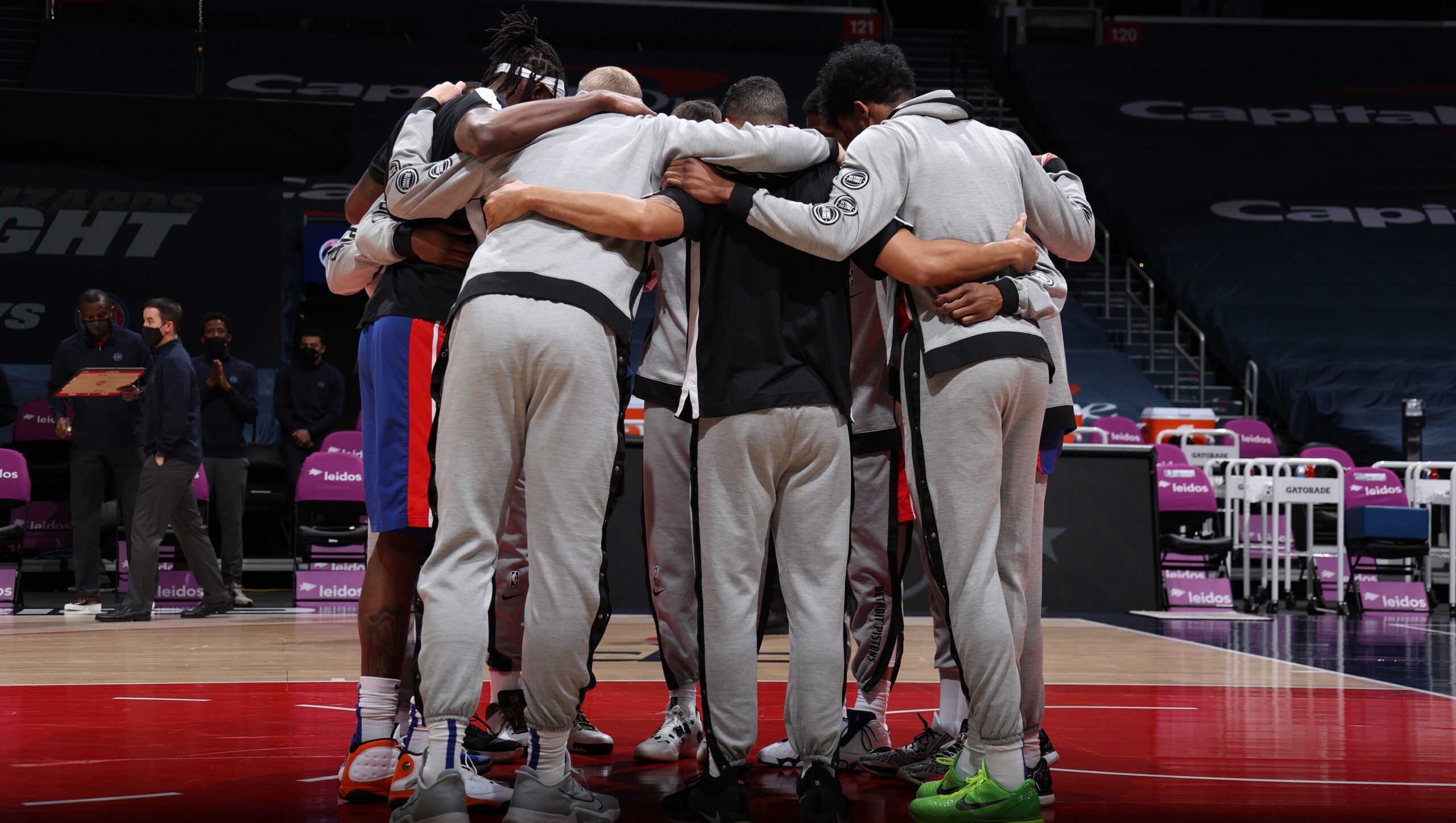 Detroit Pistons players huddle together on court before a game against the Washington Wizards.