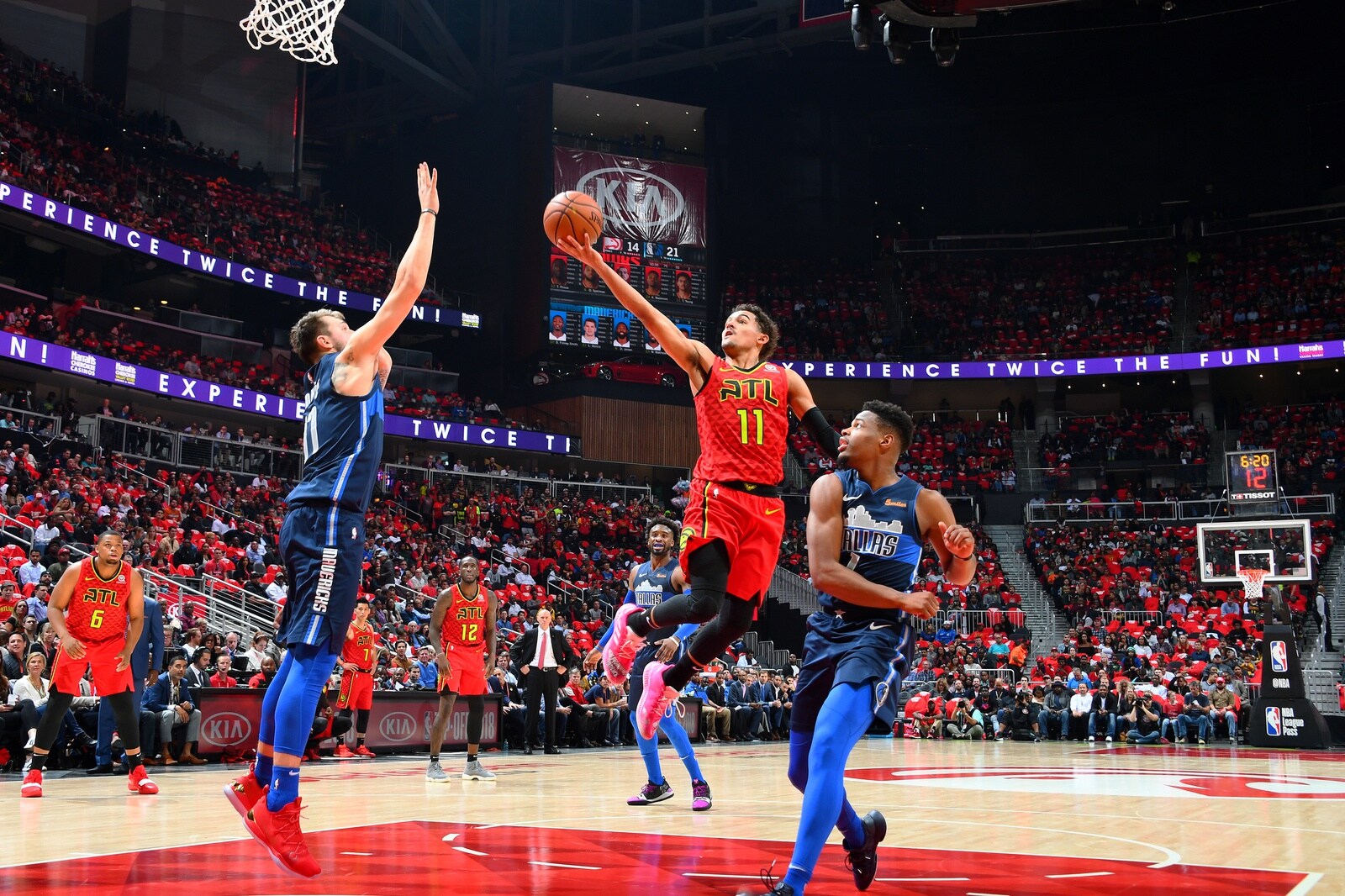 Luka Doncic #77 of the Dallas Mavericks contests the shot by Trae Young #11 of the Atlanta Hawks on October 24, 2018 at State Farm Arena in Atlanta, Georgia