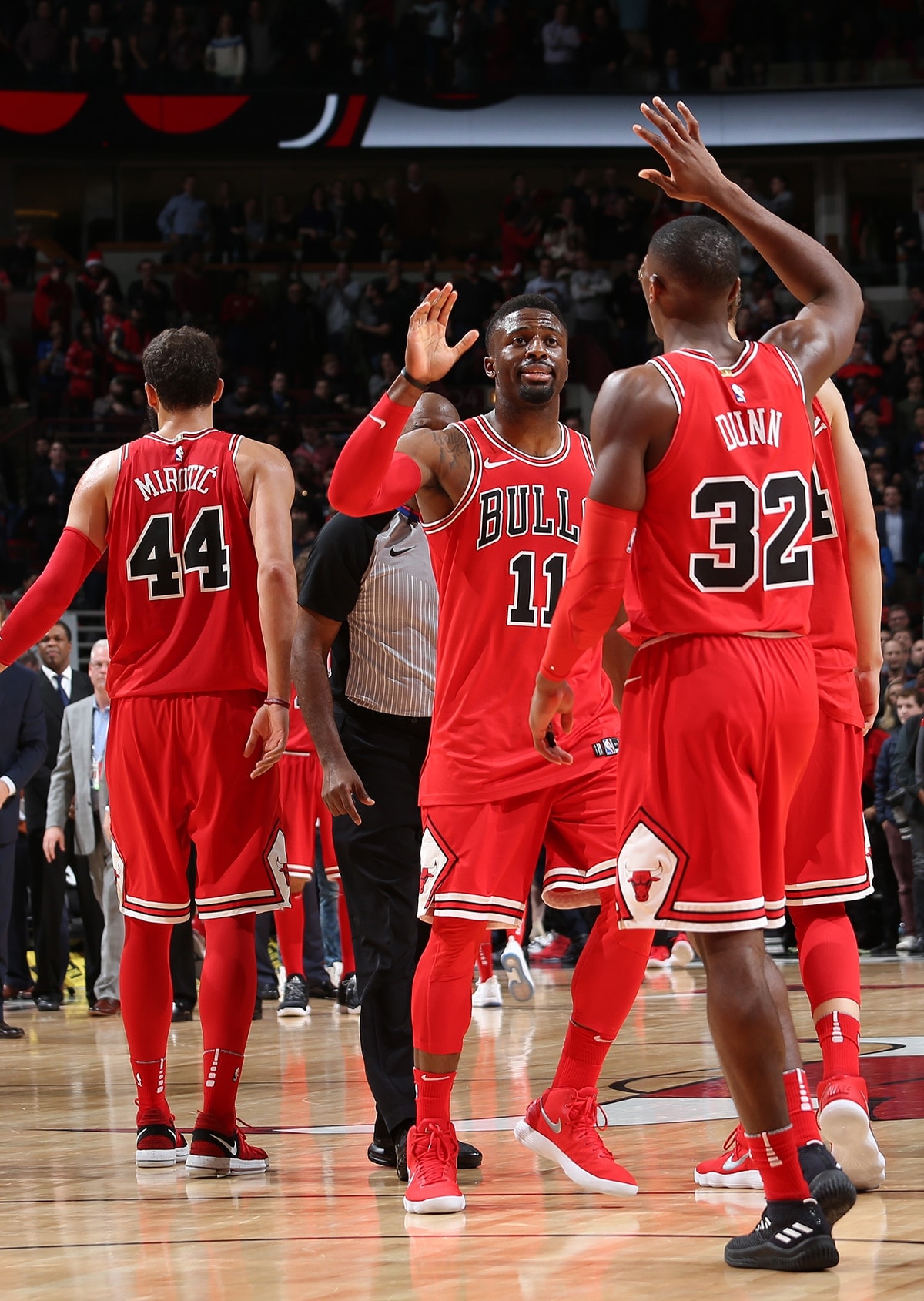 Kris Dunn and David Nwaba of the Chicago Bulls high-five during the Bulls game against the Orlando Magic at the United Center on December 20, 2017 in Chicago, Illinois.