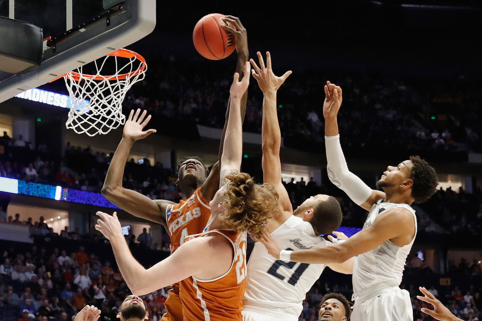 Mohamed Bamba #4 of the Texas Longhorns grabs a rebound over Kendall Stephens #21 of the Nevada Wolf Pack during the game in the first round of the 2018 NCAA Men's Basketball Tournament at Bridgestone Arena on March 16, 2018 in Nashville, Tennessee.