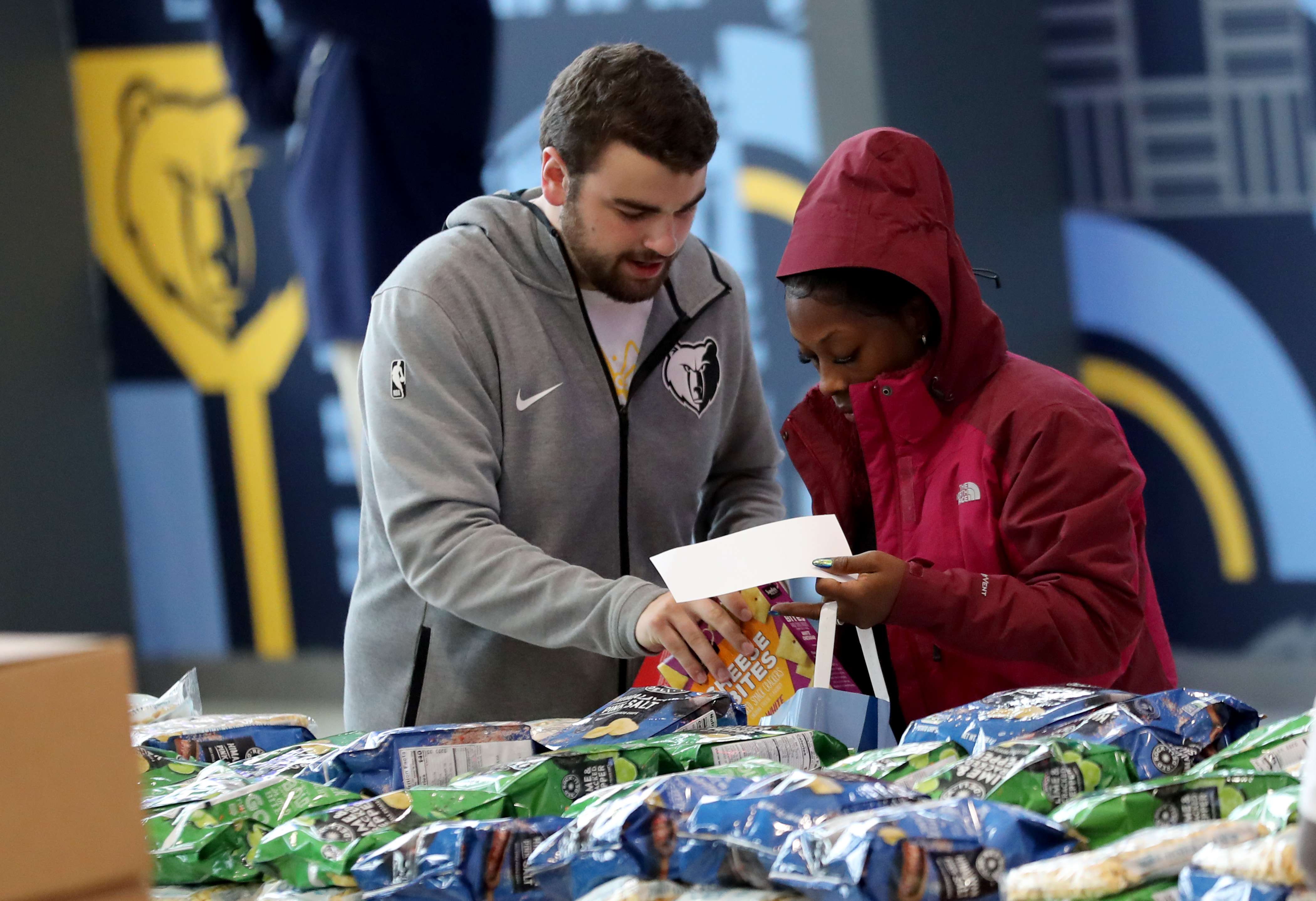 Slideshow-image: Grizzlies players, coaching staff &amp; employees provided 400 families with food &amp; necessities, courtesy of Feed the Children. Families in att...