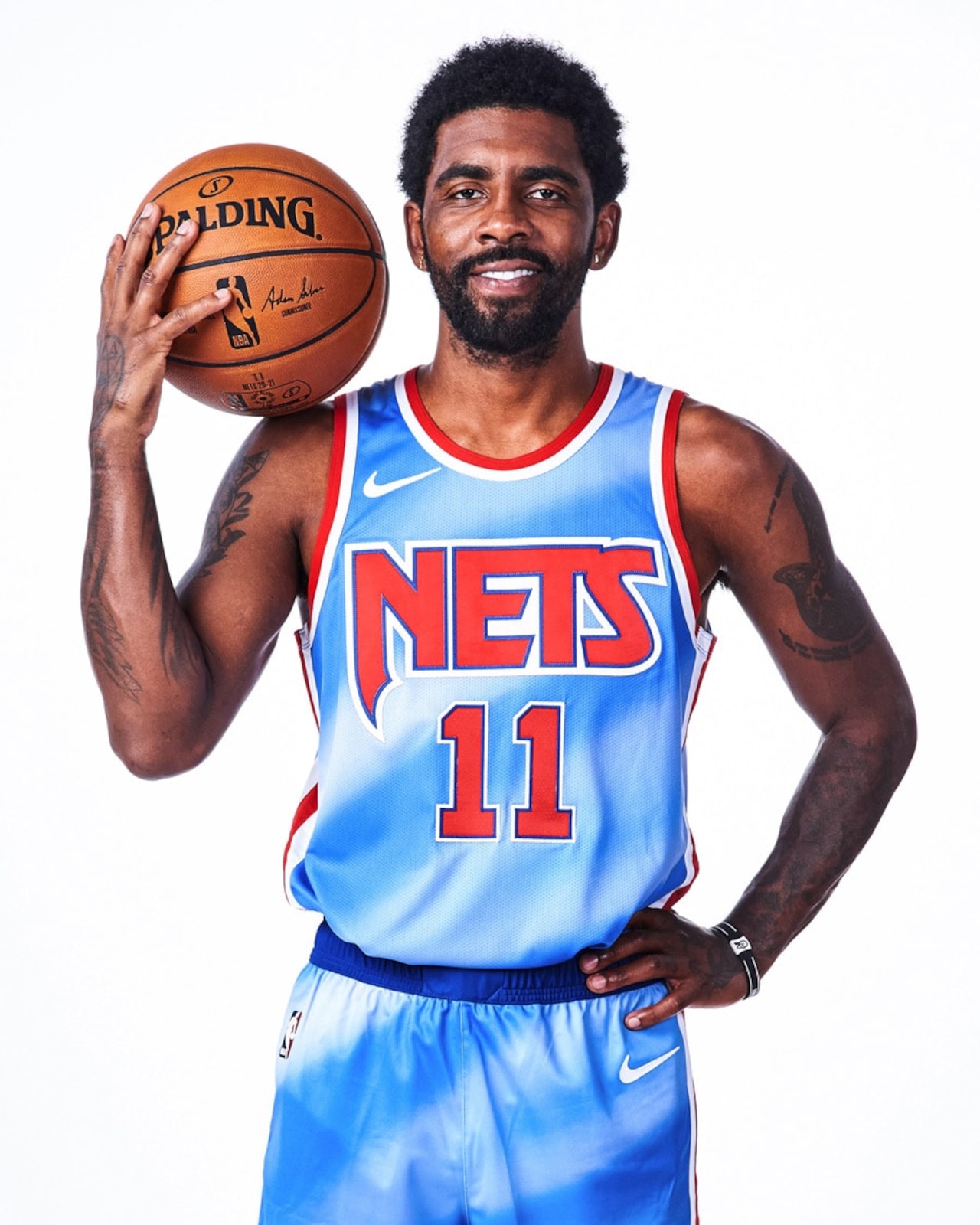 Kyrie Irving wearing the Brooklyn Nets light blue and red Classic Edition jersey inspired by the team's New Jersey history