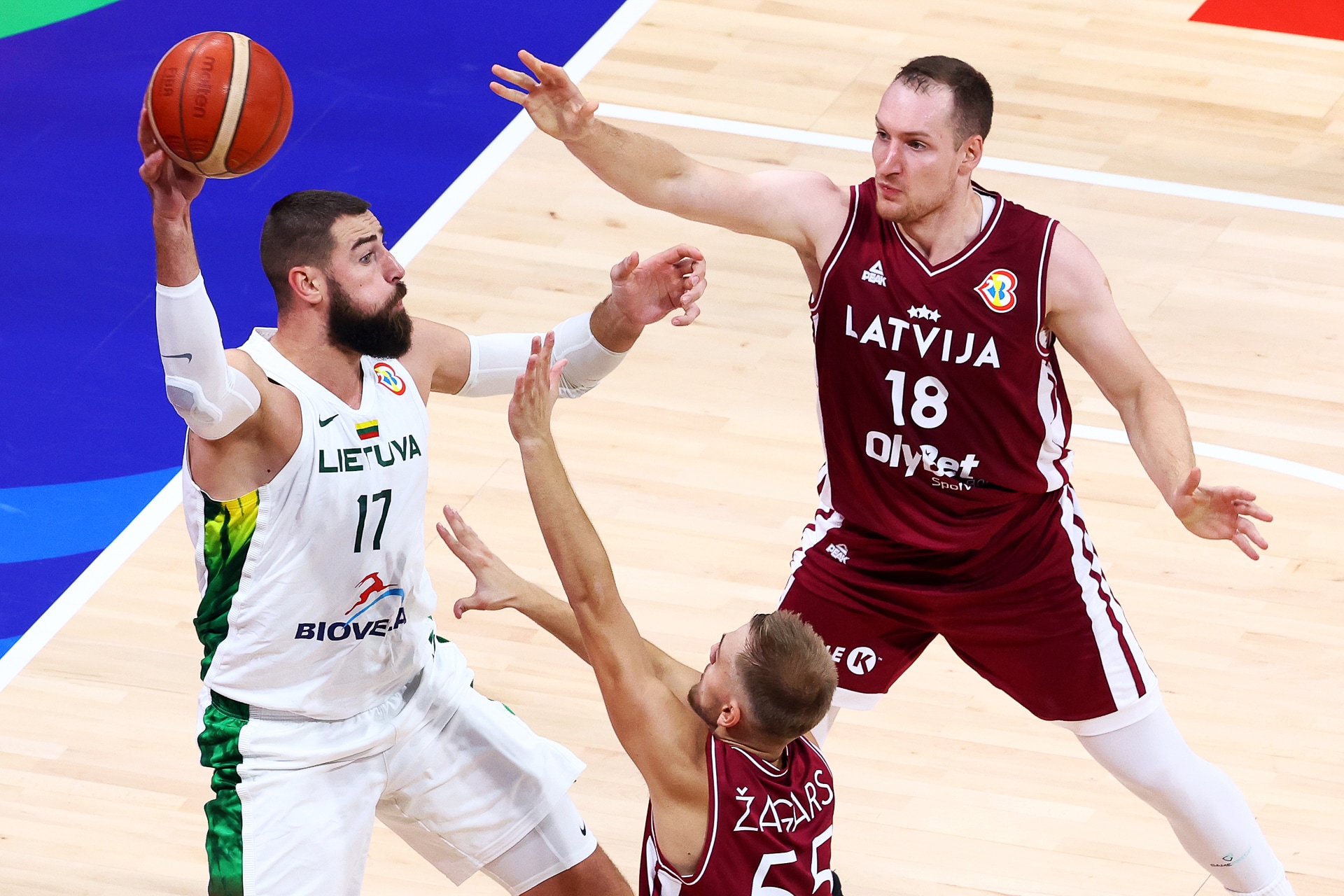 Slideshow-image: MANILA, PHILIPPINES - SEPTEMBER 09: Jonas Valanciunas #17 of Lithuania looks for a pass against Arturs Zagars #55 (C) and Klavs Cavars #18 of Latvi...