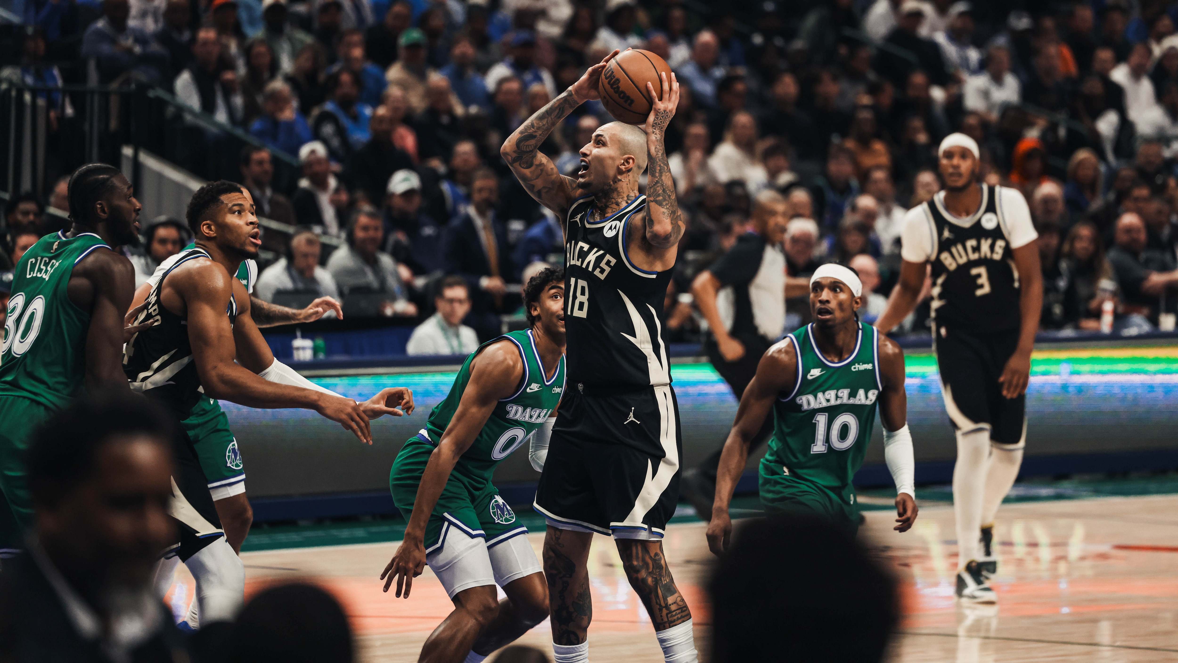 The Milwaukee Bucks and Dallas Mavericks in action