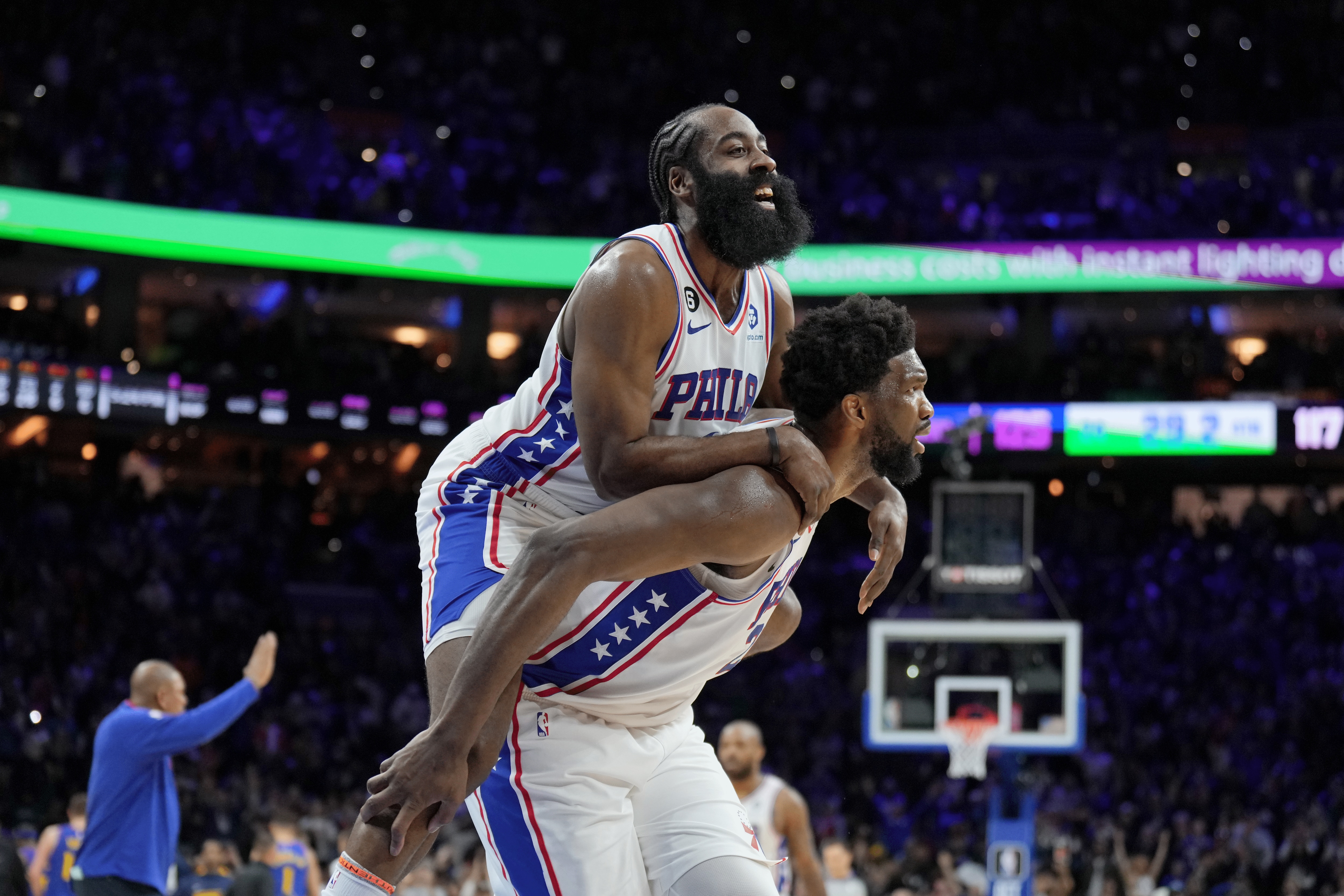 James Harden jumps on Joel Embiid's back