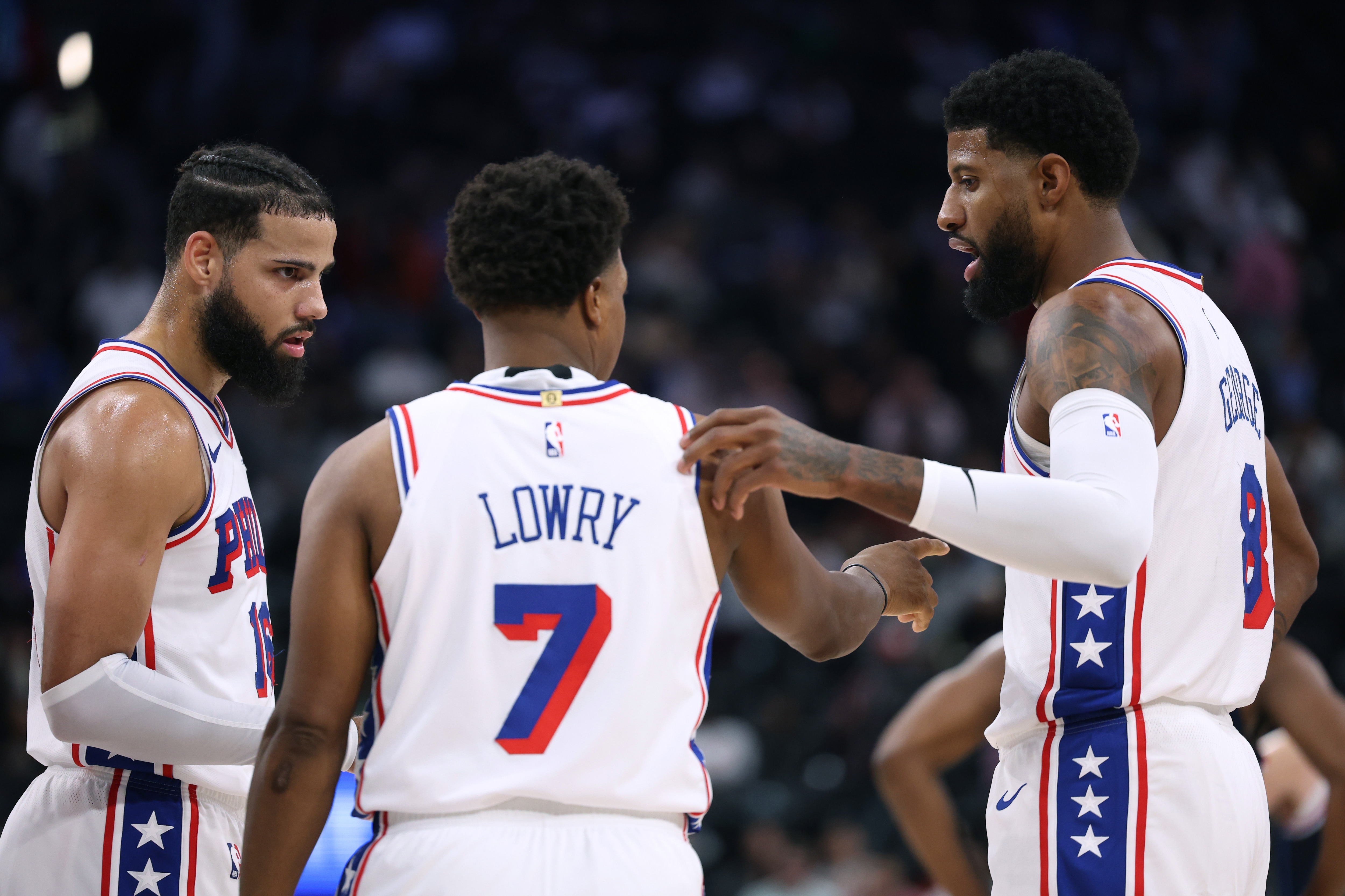 Paul George #8, Kyle Lowry #7 and Caleb Martin #16 of the Philadelphia 76ers talk during a timeout