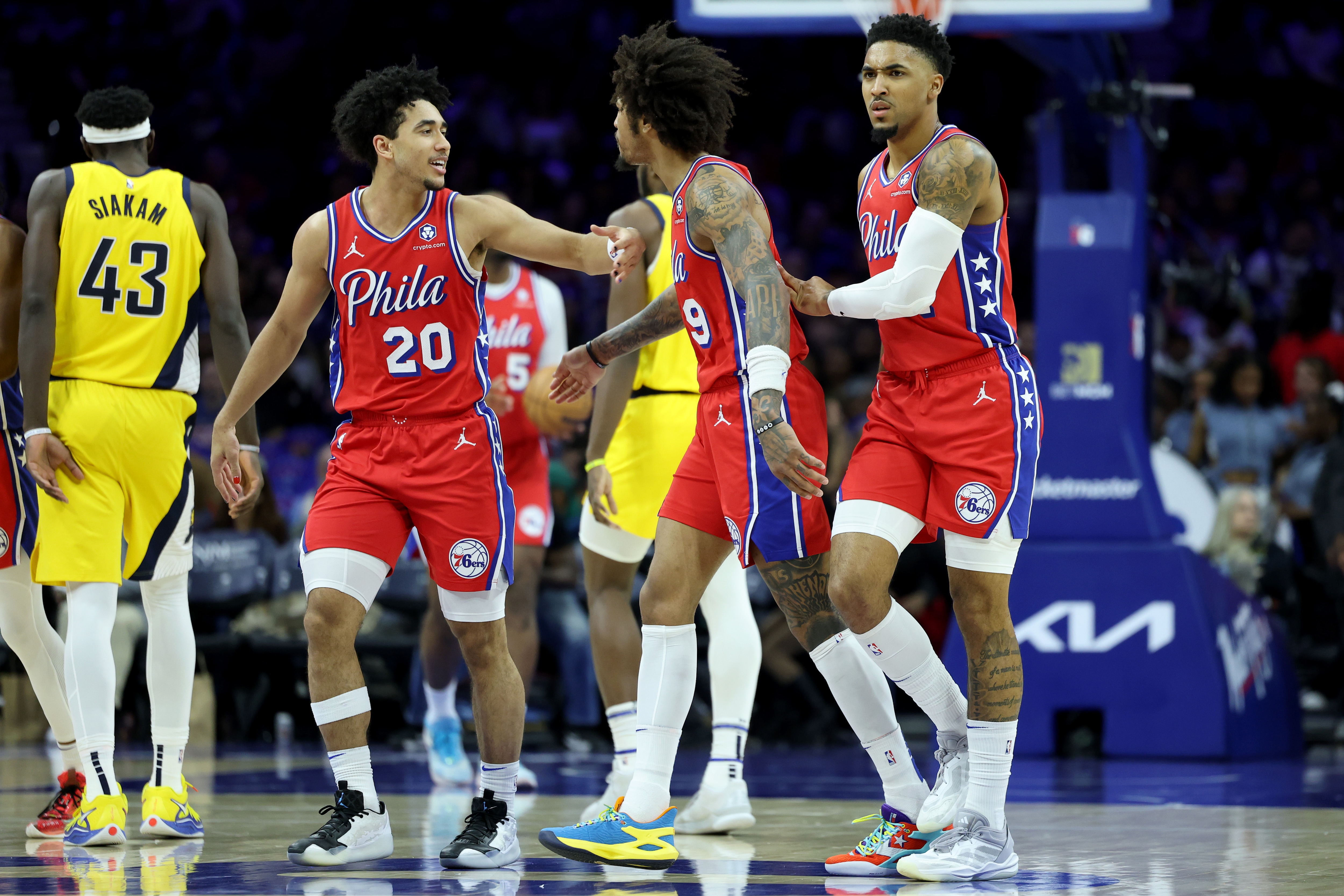 Jared McCain #20 celebrates with Kelly Oubre Jr. #9 and KJ Martin #1 of the Philadelphia 76ers