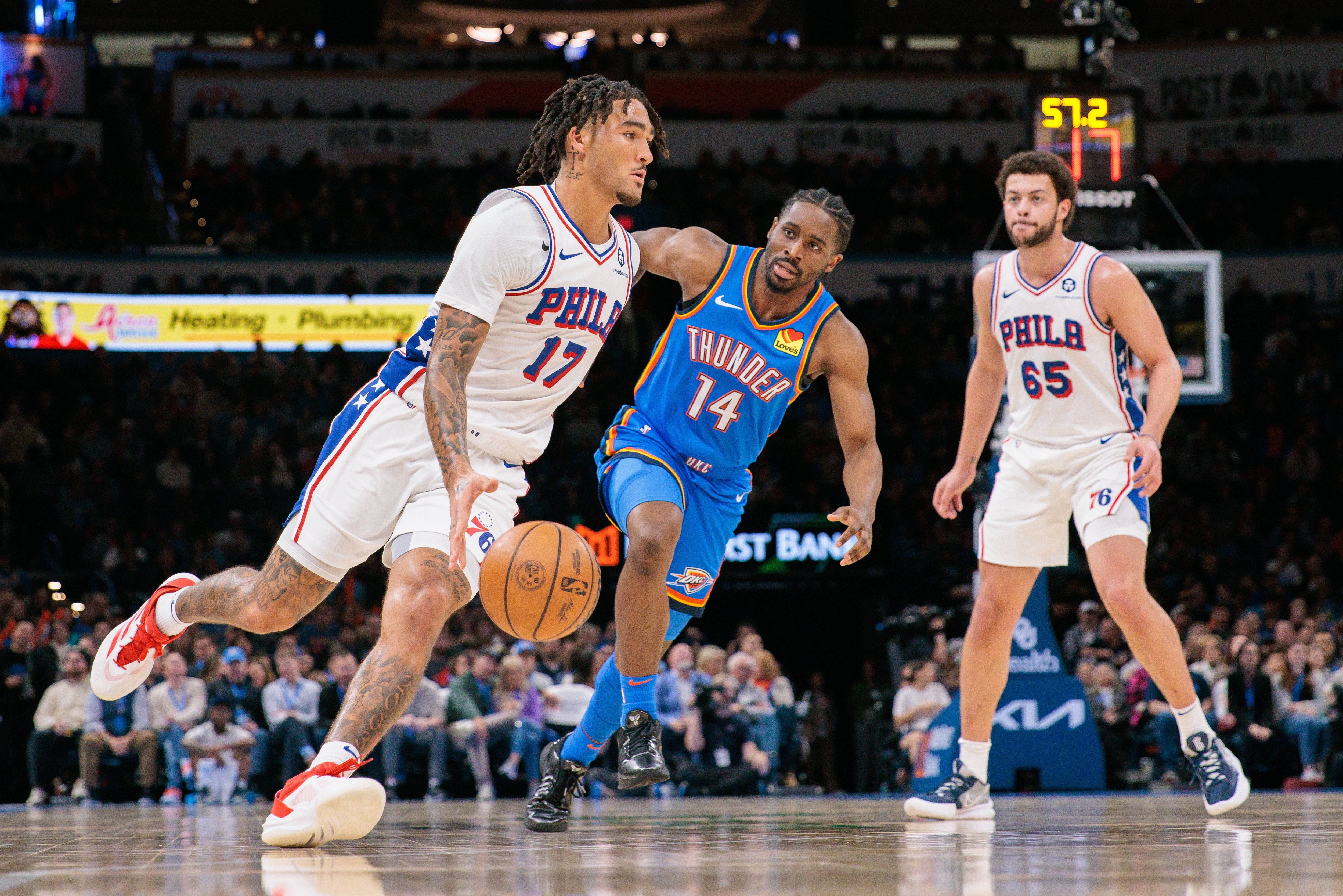 Jalen Hood-Schifino #17 of the Philadelphia 76ers drives around Adam Flagler #14 of the Oklahoma City Thunder