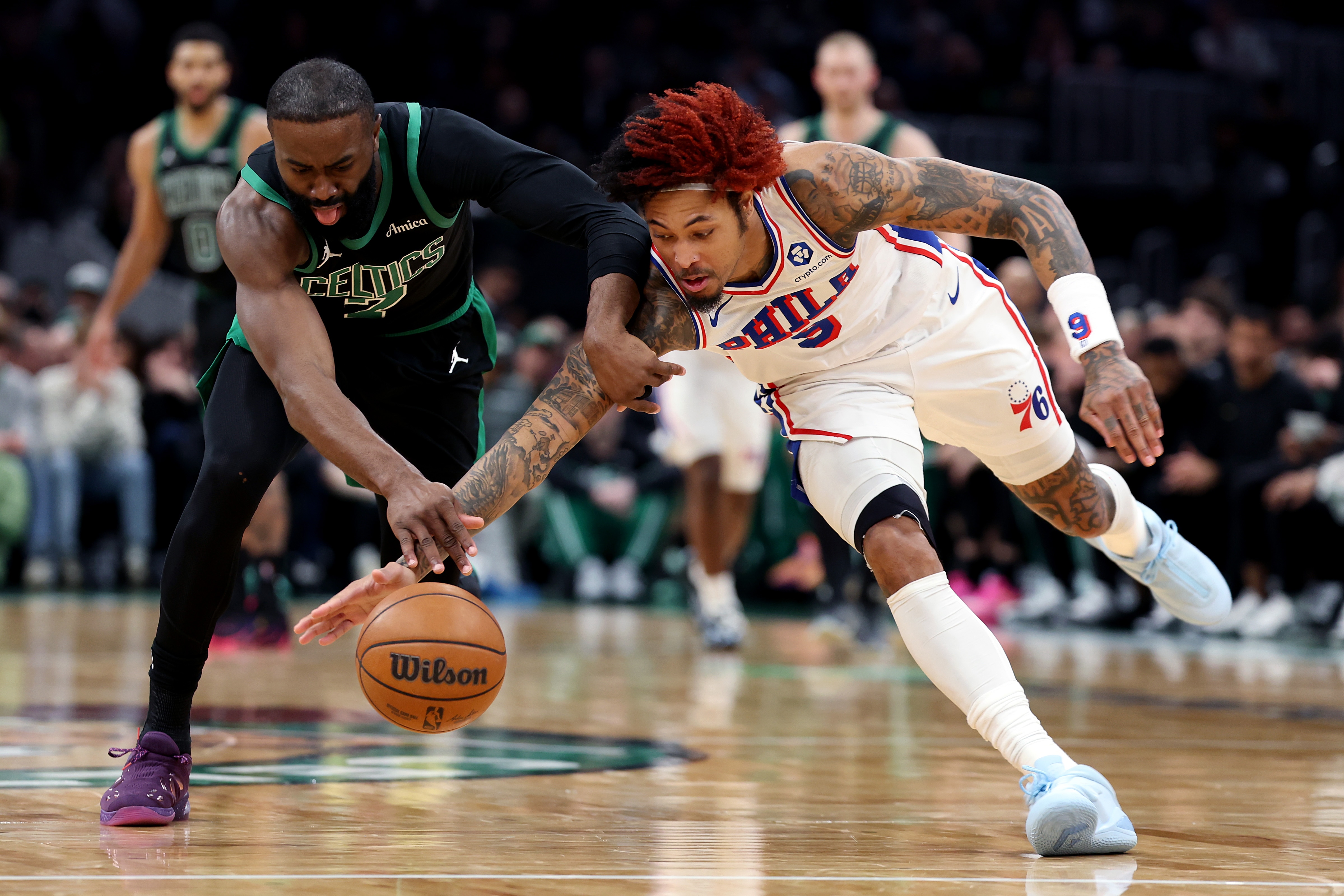  Kelly Oubre Jr. #9 of the Philadelphia 76ers and Jaylen Brown #7 of the Boston Celtics battle for a loose ball