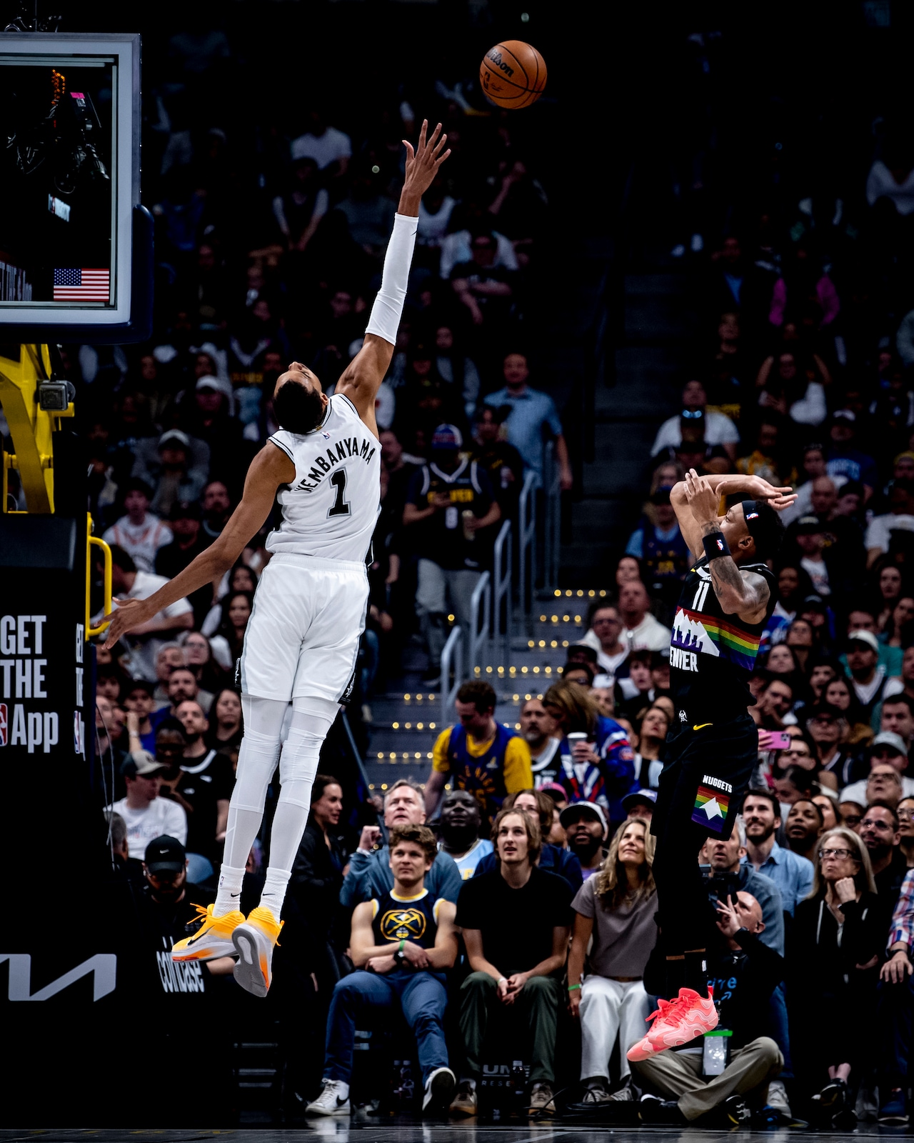 Victor Wembanyama contests a Denver shot in his Spurs uniform