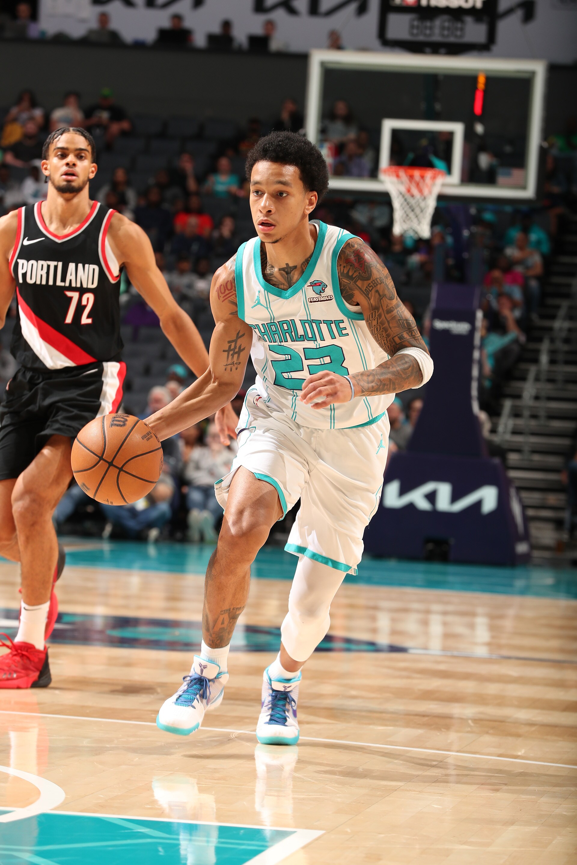 Slideshow-image: CHARLOTTE, NC - APRIL 3: Tre Mann #23 of the  Charlotte Hornets goes to the basket during the game on April 3, 2024 at Spectrum Center in Charlotte...