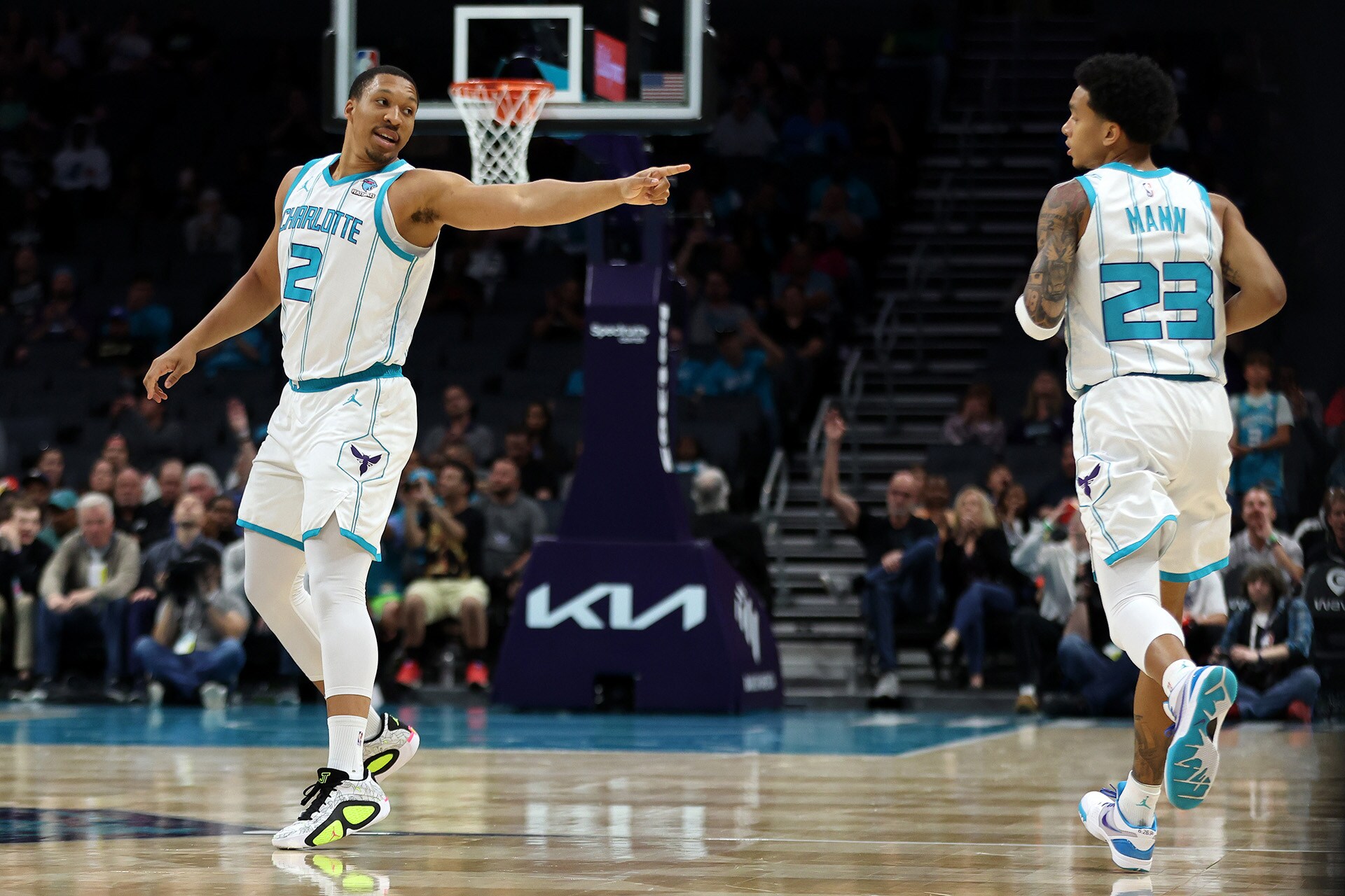 Slideshow-image: CHARLOTTE, NORTH CAROLINA - APRIL 03: Grant Williams #2 of the Charlotte Hornets points at Tre Mann #23 after an assist in the first half against t...